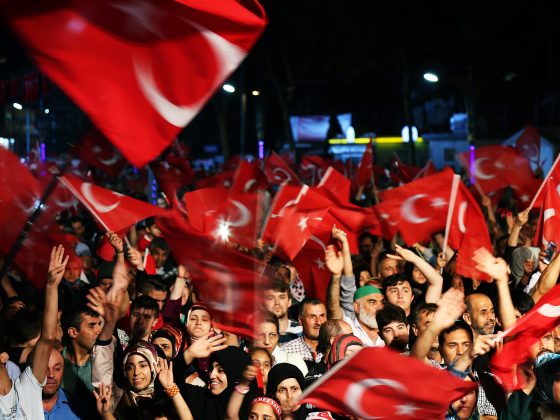 Crowd of people waving Turkish flags